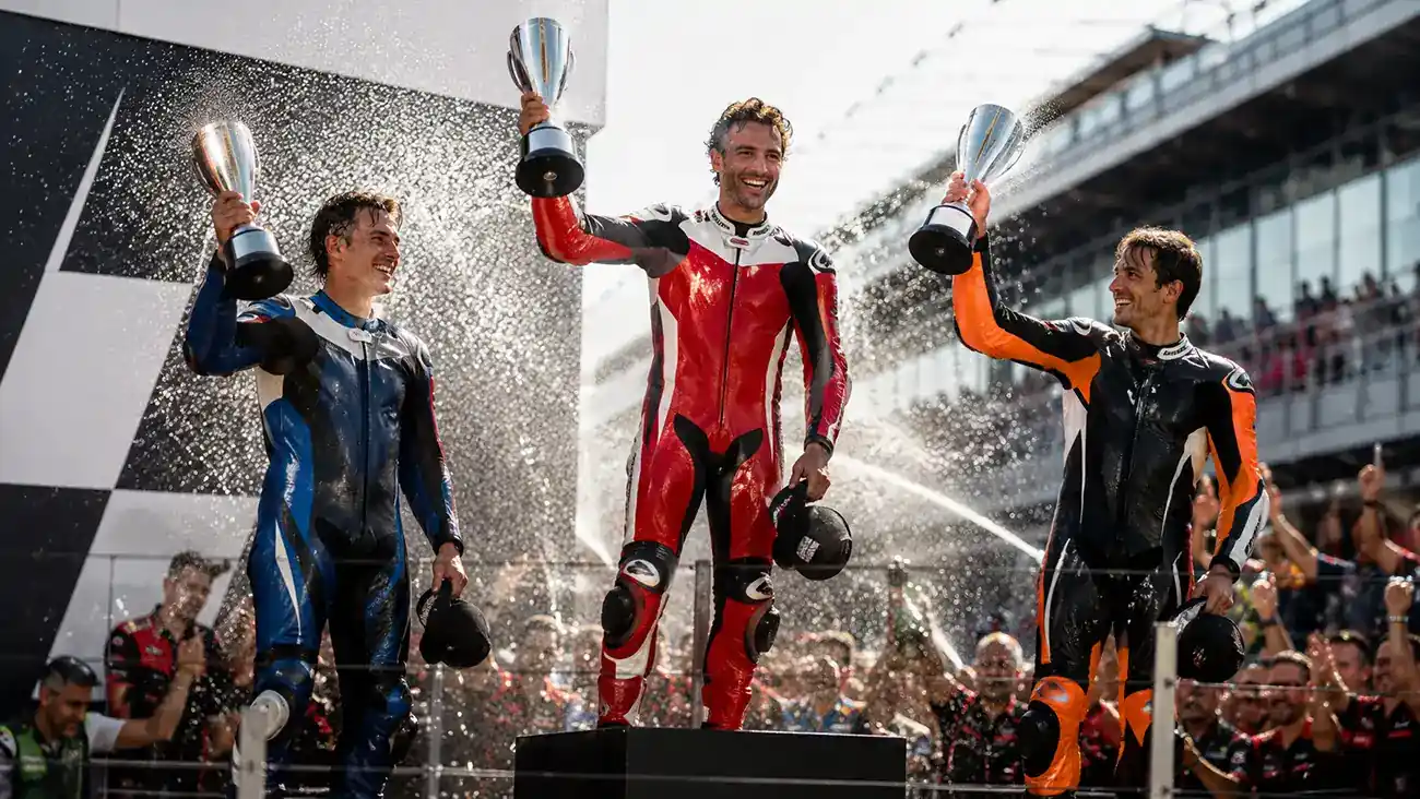 Podio MotoGP con i primi tre piloti che alzano i trofei dopo il Gran Premio